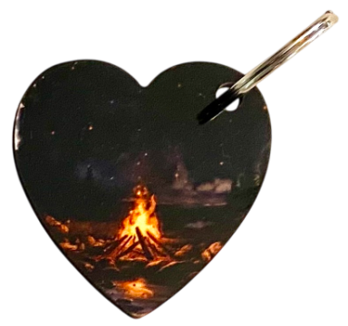 Herzförmige Holzbretter mit einem lodernden Lagerfeuer im Dunkeln.